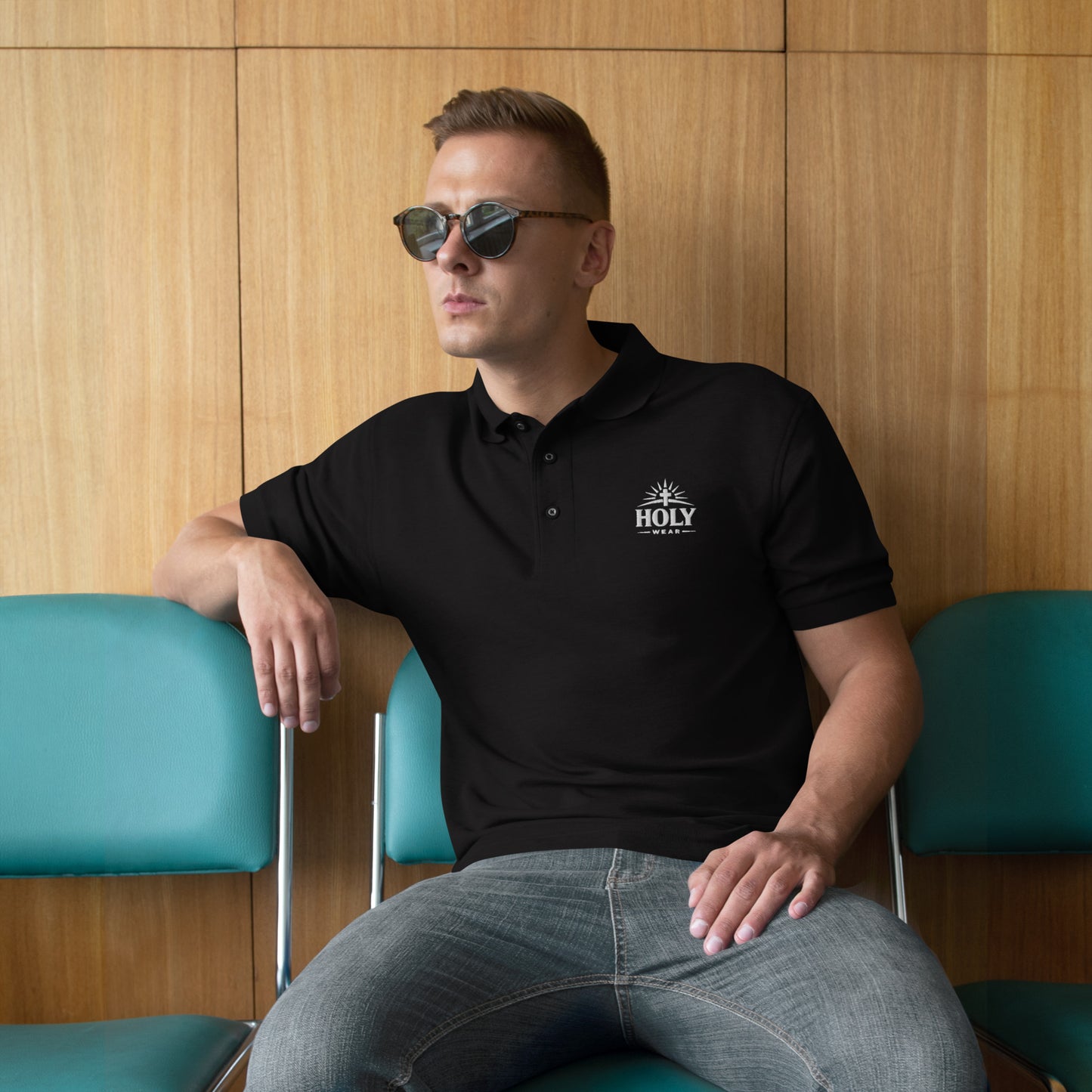 Model wearing a black Christian men’s premium embroidered polo shirt with Holy Wear logo, faith-based apparel

