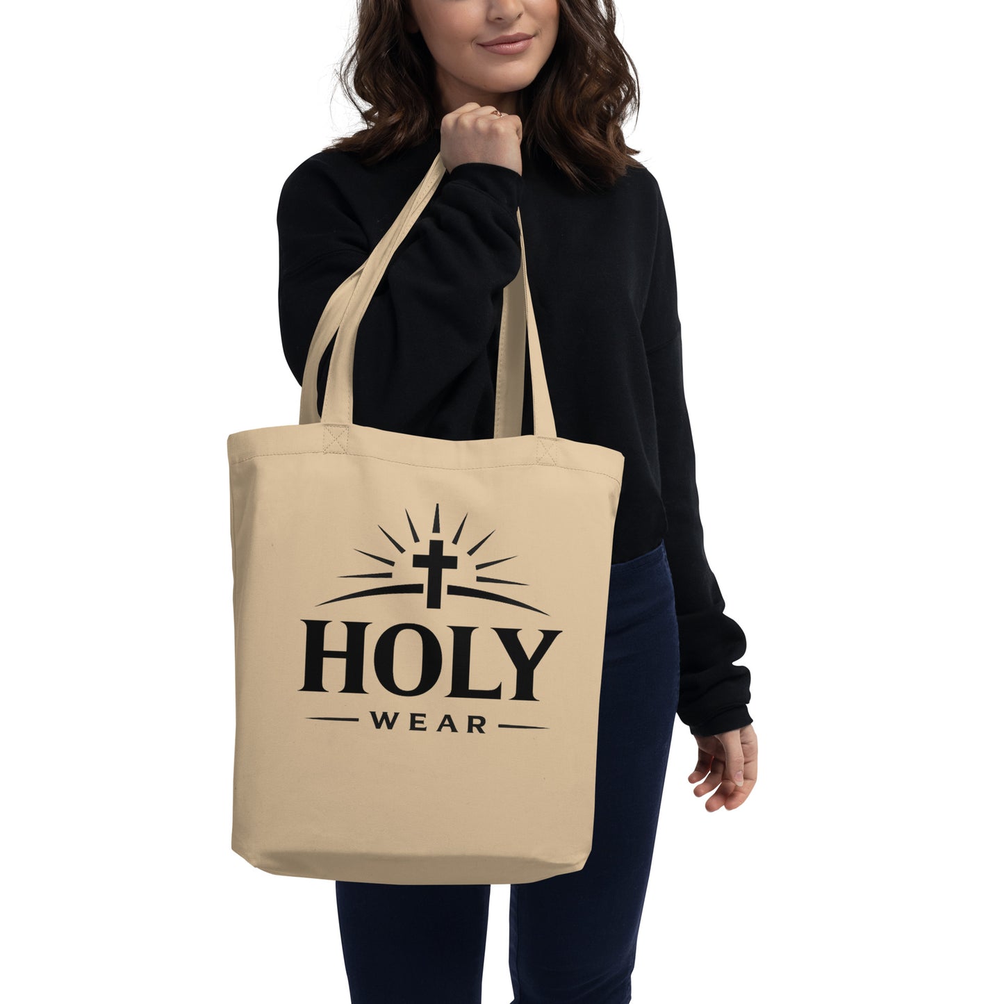 Natural cotton Christian faith eco tote bag featuring the Holy Wear logo worn by a model
