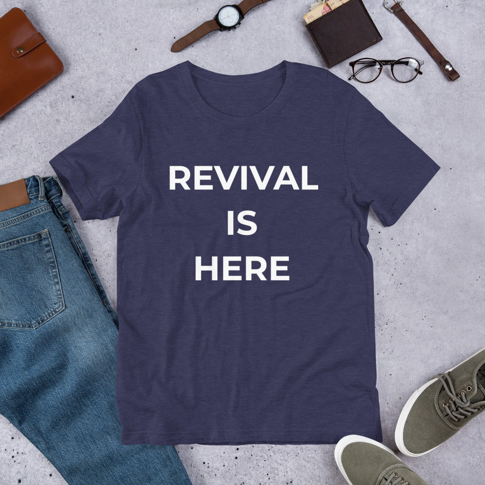 Flat lay of black heather unisex Christian revival t-shirt with “Revival Is Here” text design
