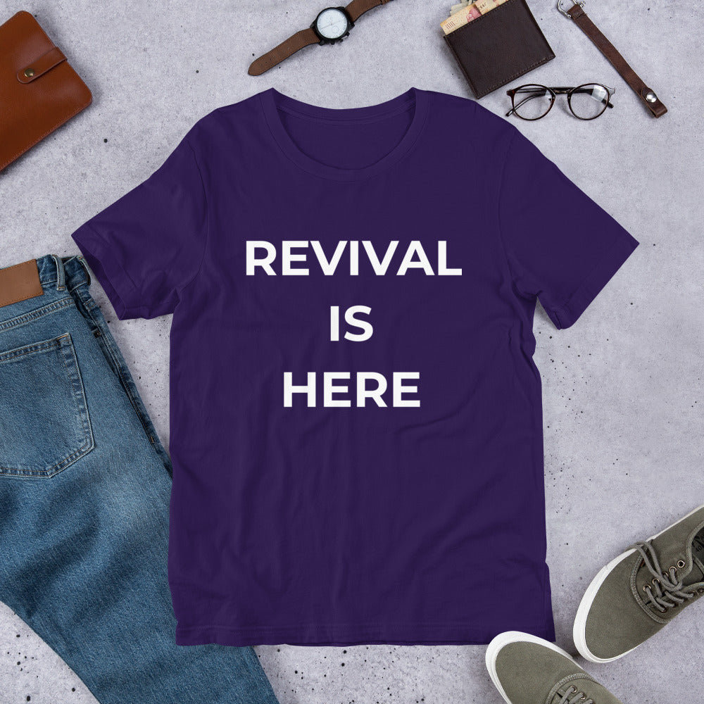 Flat lay of black heather unisex Christian revival t-shirt with “Revival Is Here” text design
