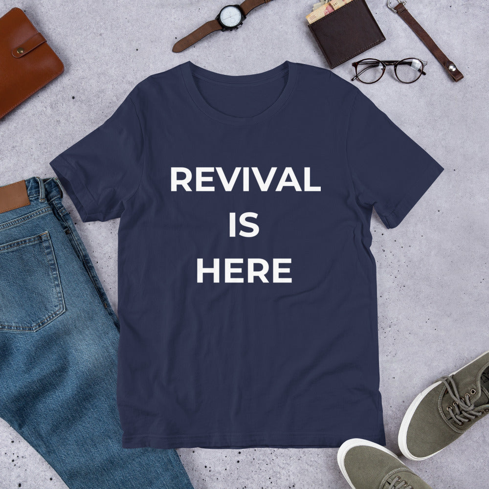 Flat lay of black heather unisex Christian revival t-shirt with “Revival Is Here” text design
