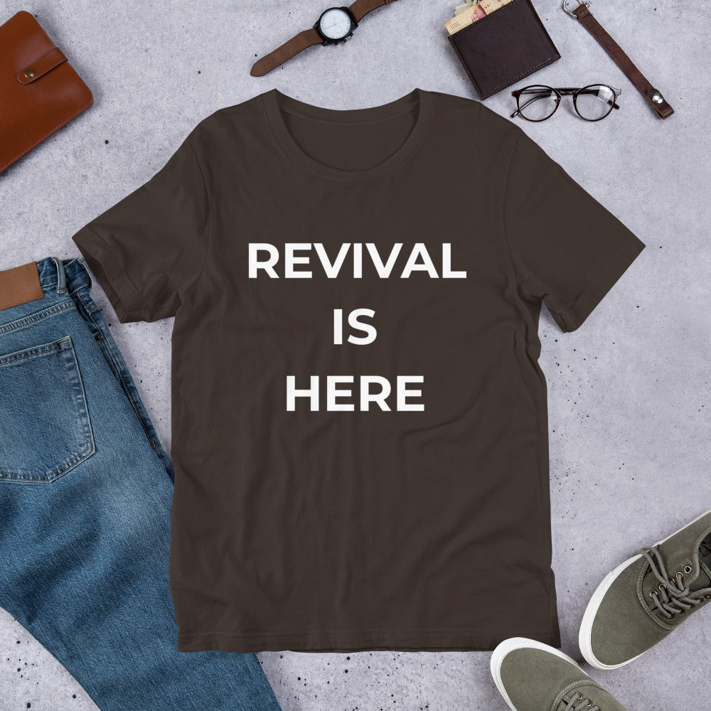 Flat lay of black heather unisex Christian revival t-shirt with “Revival Is Here” text design
